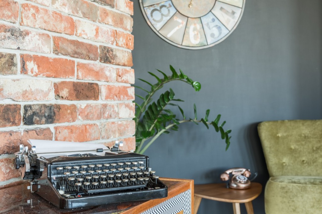 Typewriter against brick wall